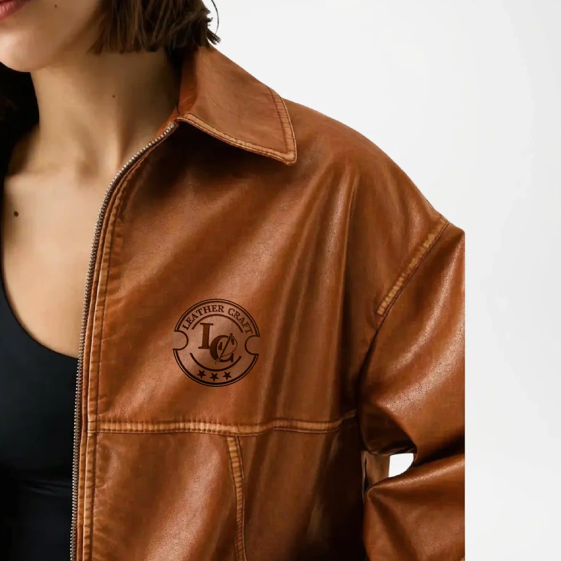 Brown leather jacket with a brand logo on a neutral background