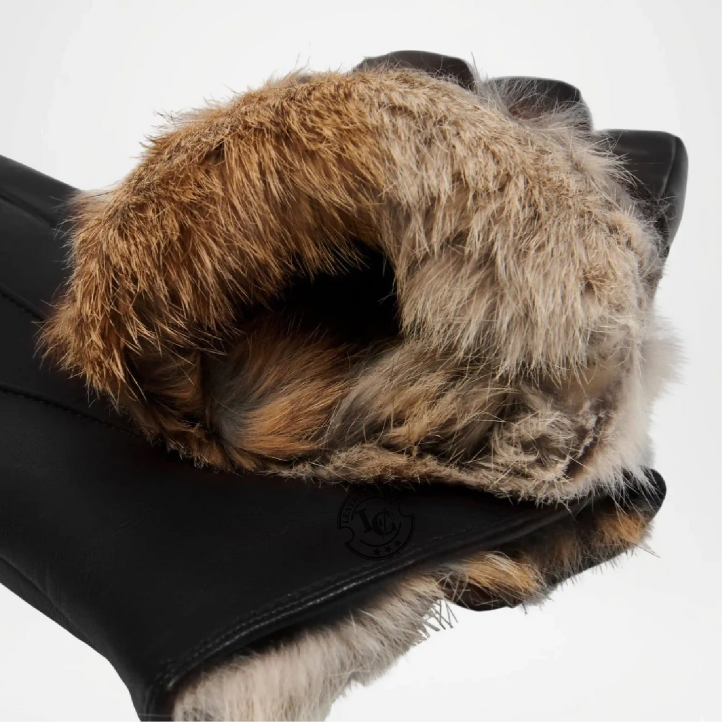 Close-up of a black glove with brown fur cuff on a white background