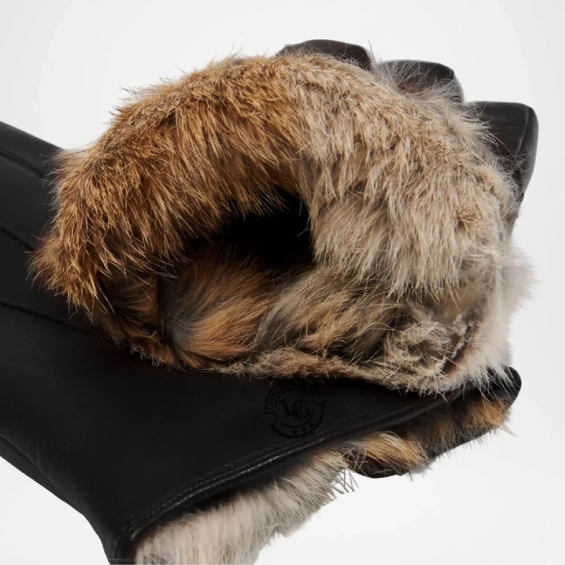 Close-up of a black glove with brown fur cuff on a white background