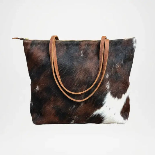 Brown and white cowhide bag with brown leather handle