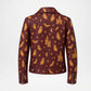 A dark brown faux leather jacket with a repeating Halloween print of orange ghosts, bats, stars, castles, and crescent moons, shown from the back on a white background.
