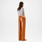 Woman wearing brown leather pants back view