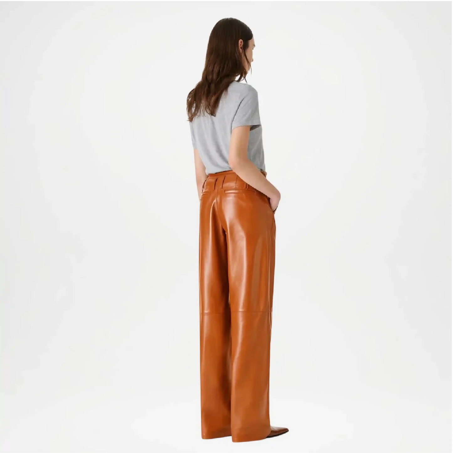 Woman wearing brown leather pants back view