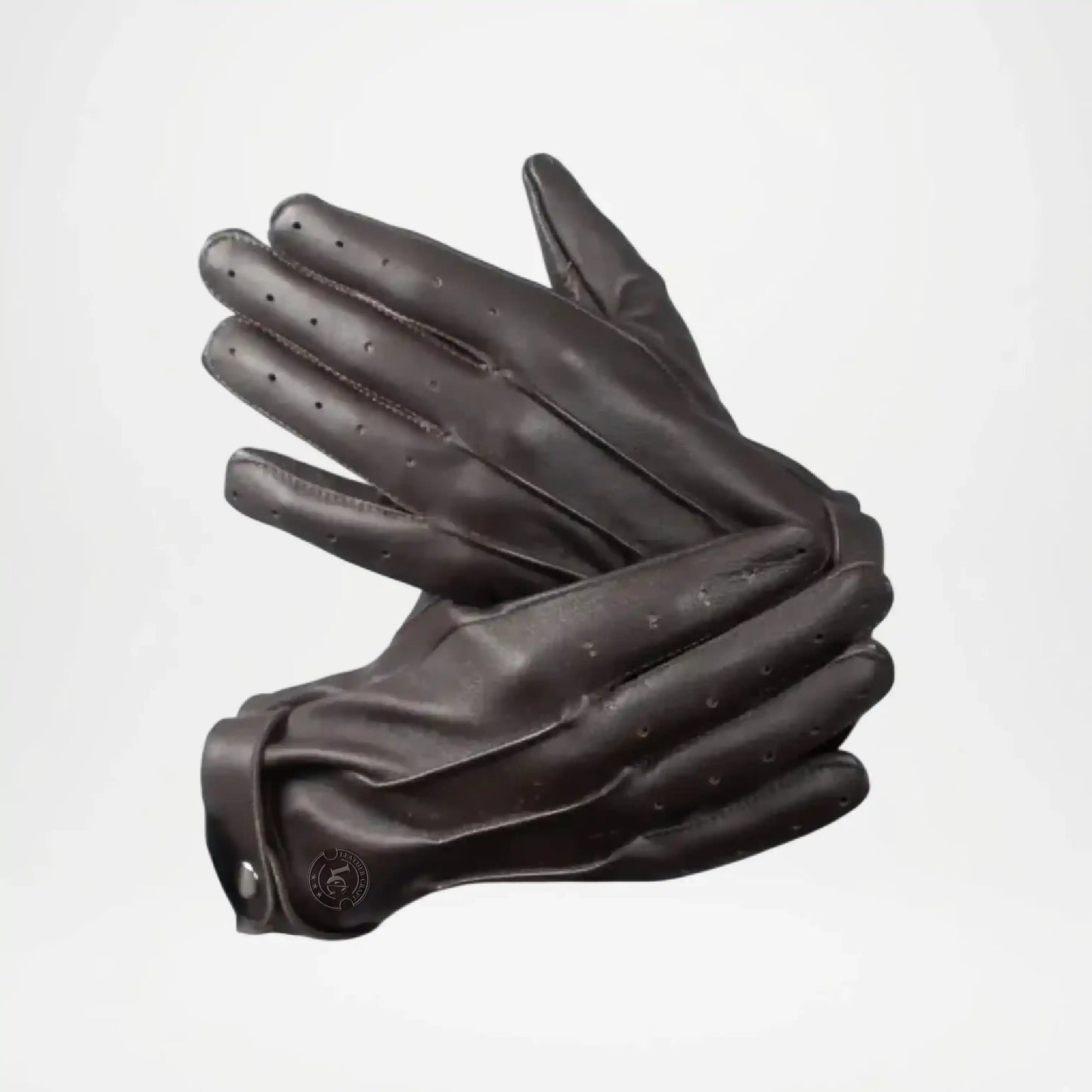 Pair of black leather gloves on a light gray background