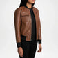Brown leather jacket worn by a person on a white background