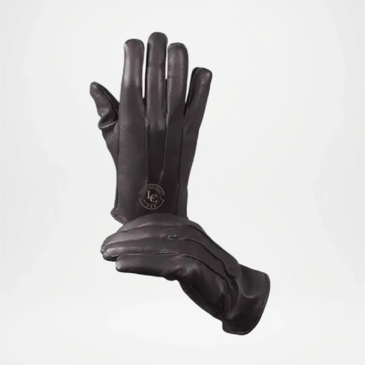 Pair of black leather gloves on a light gray background