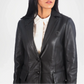 Black leather jacket worn by a person on a white background