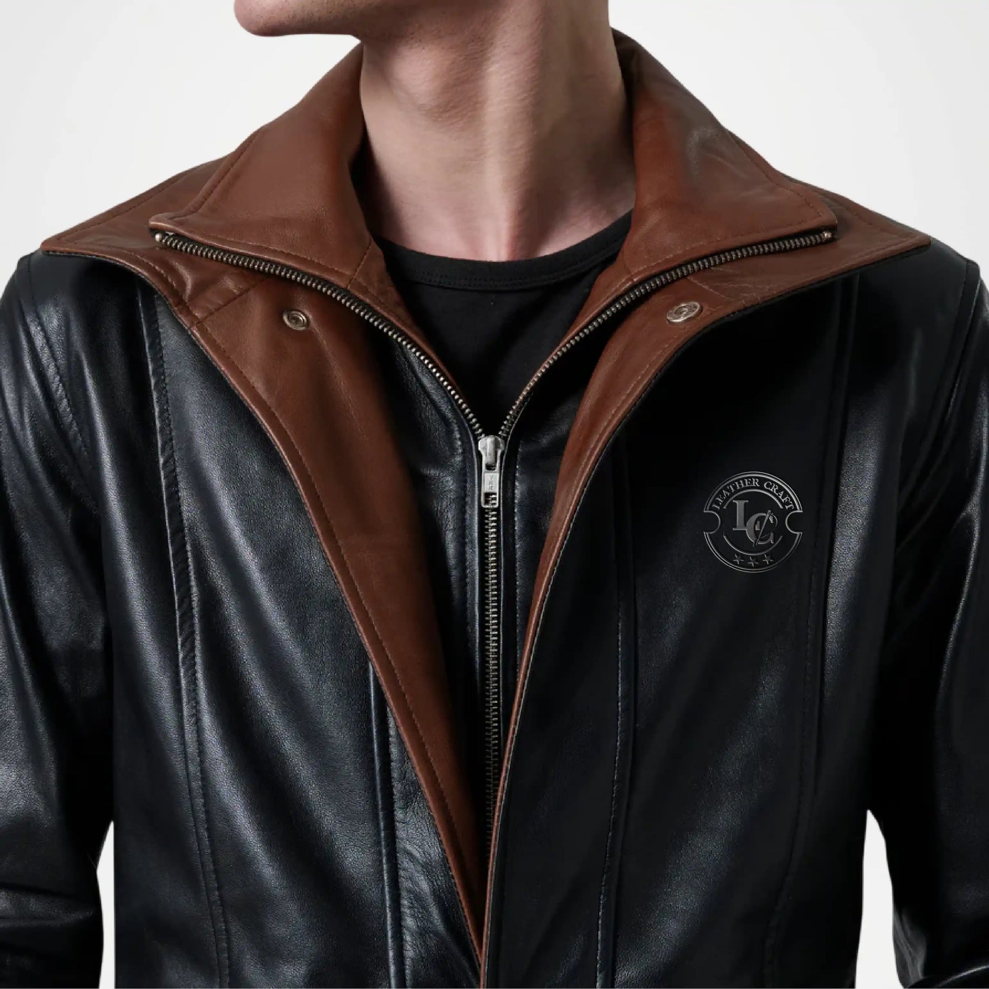 Black leather jacket with brown collar and zipper, featuring a logo on the chest.