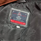 Close-up of a leather craft label on a dark leather surface