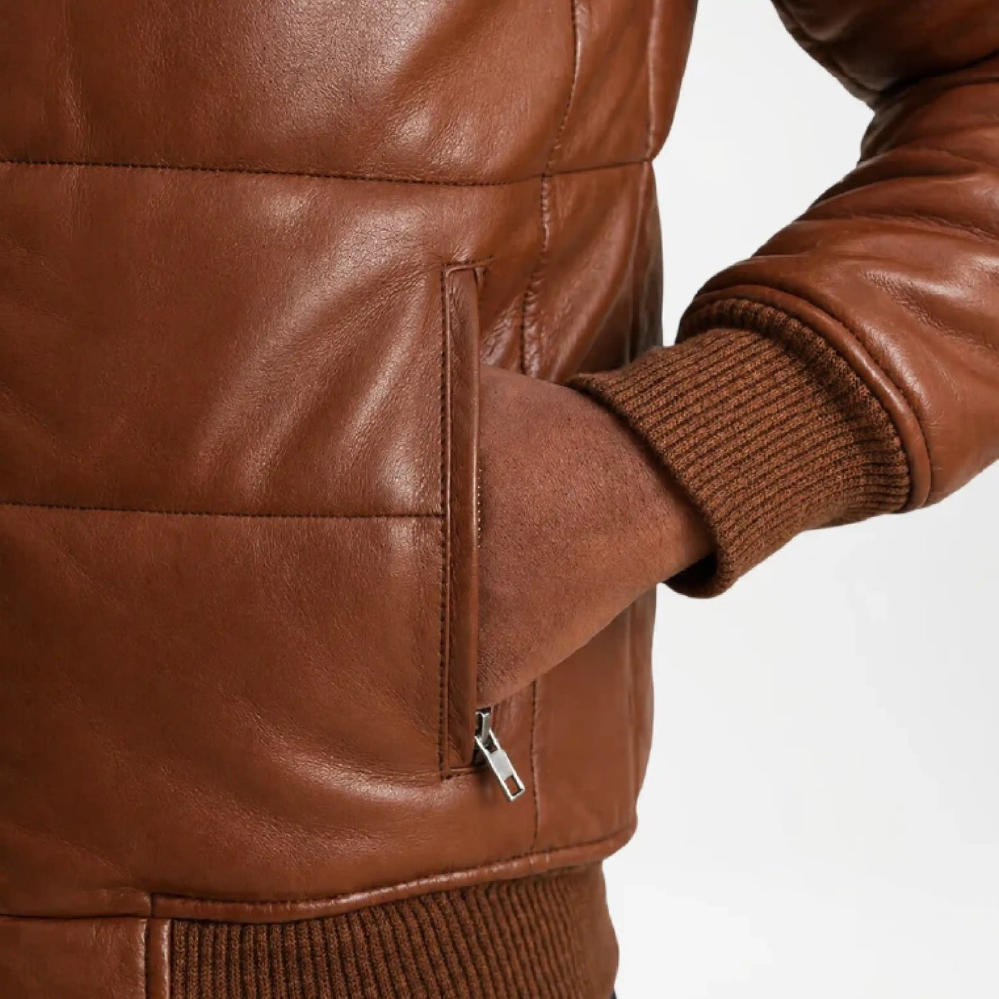 Close-up of a brown leather jacket with a zipper pocket 