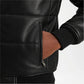 Close-up of a person wearing a black leather jacket with a white background