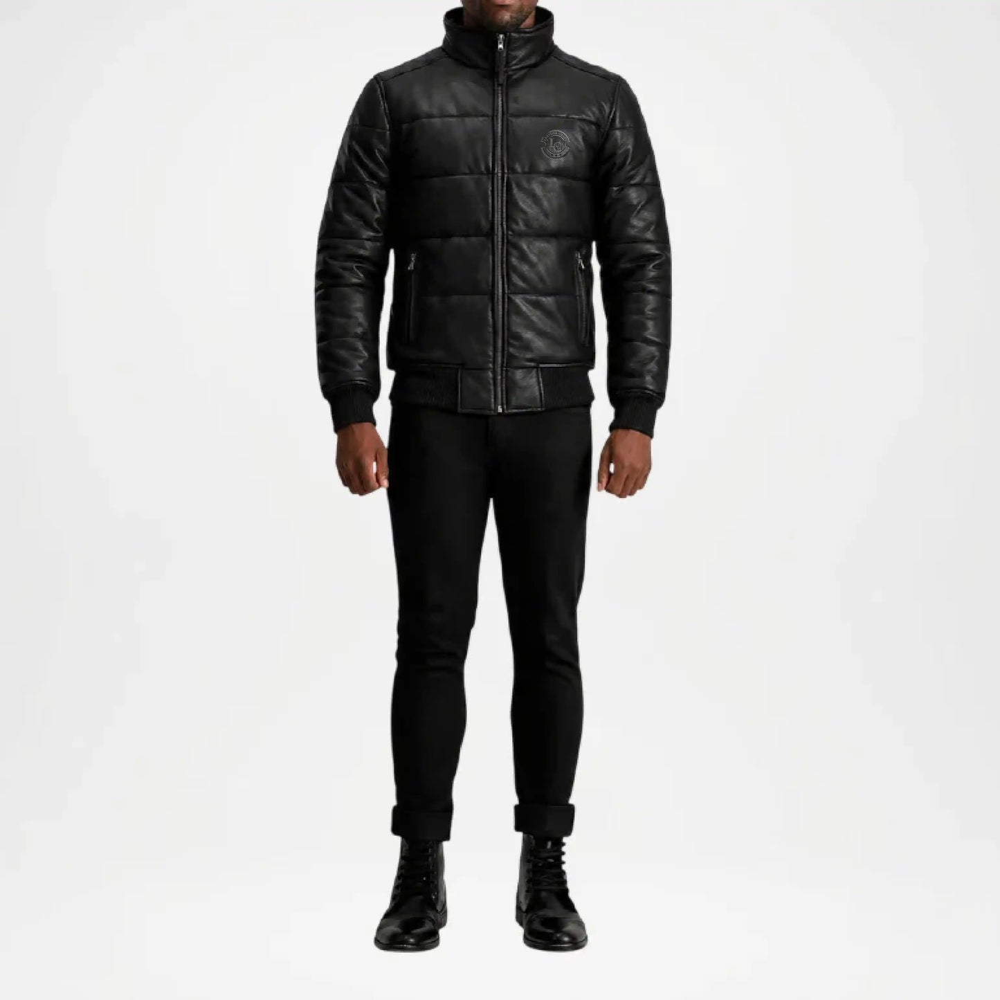 Person wearing a black leather jacket and pants on a white background