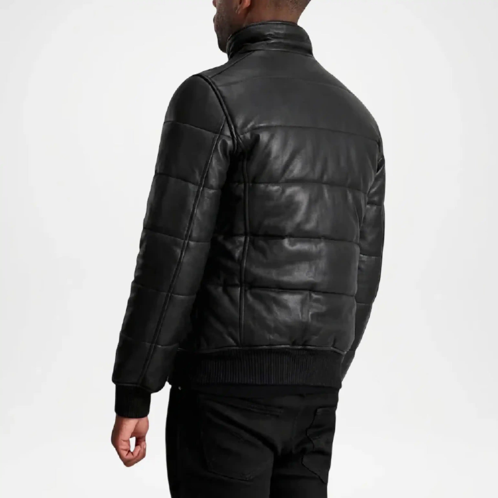 Person wearing a black quilted leather jacket on a white background