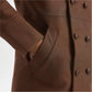 Close-up of a brown coat with buttons and a pocket 