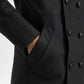 Close-up of a black coat with buttons and a pocket on a white background