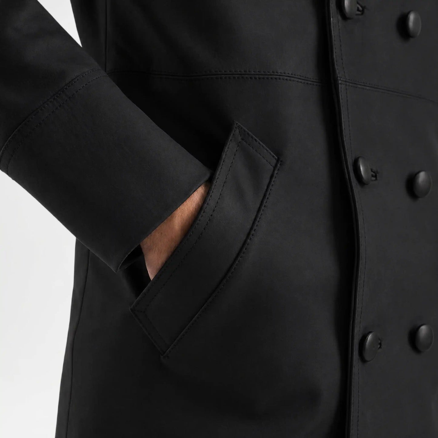 Close-up of a black coat with buttons and a pocket on a white background
