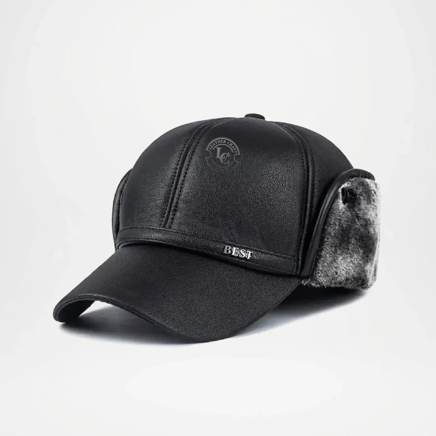 Black leather cap with fur trim on a light gray background