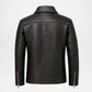 Black textured leather jacket shown from the back, featuring a high collar, vertical seam details, and silver zipper accents on the sleeves, set against a plain white background.