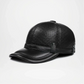 Black leather cap on a light gray background