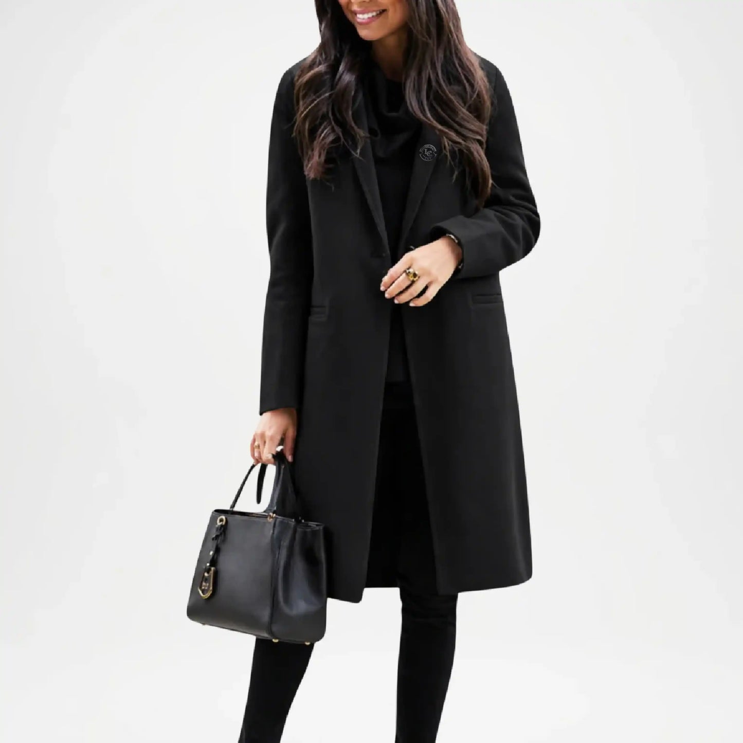 Woman wearing a black coat holding a black handbag 