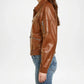 Brown leather jacket worn by a person on a white background