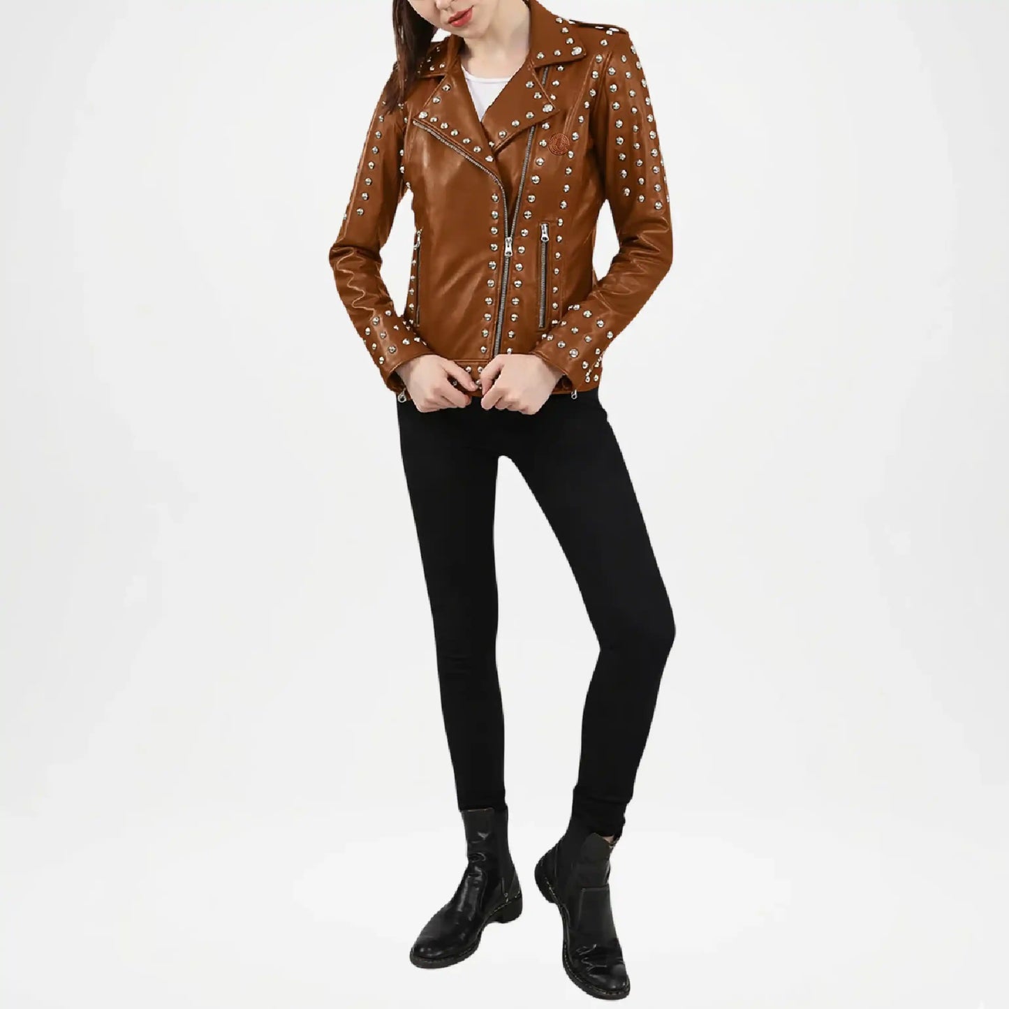 Person wearing a brown leather jacket with studs on a white background