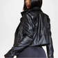 Black leather jacket worn by a person on a white background