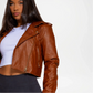 Woman wearing a brown leather jacket on a white background
