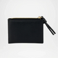 Black & cream leather pouch with a gold zipper on a white background