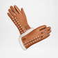 Brown leather glove with studs and white fur lining 