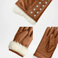 Brown leather gloves with white fur lining and studded details on a white background