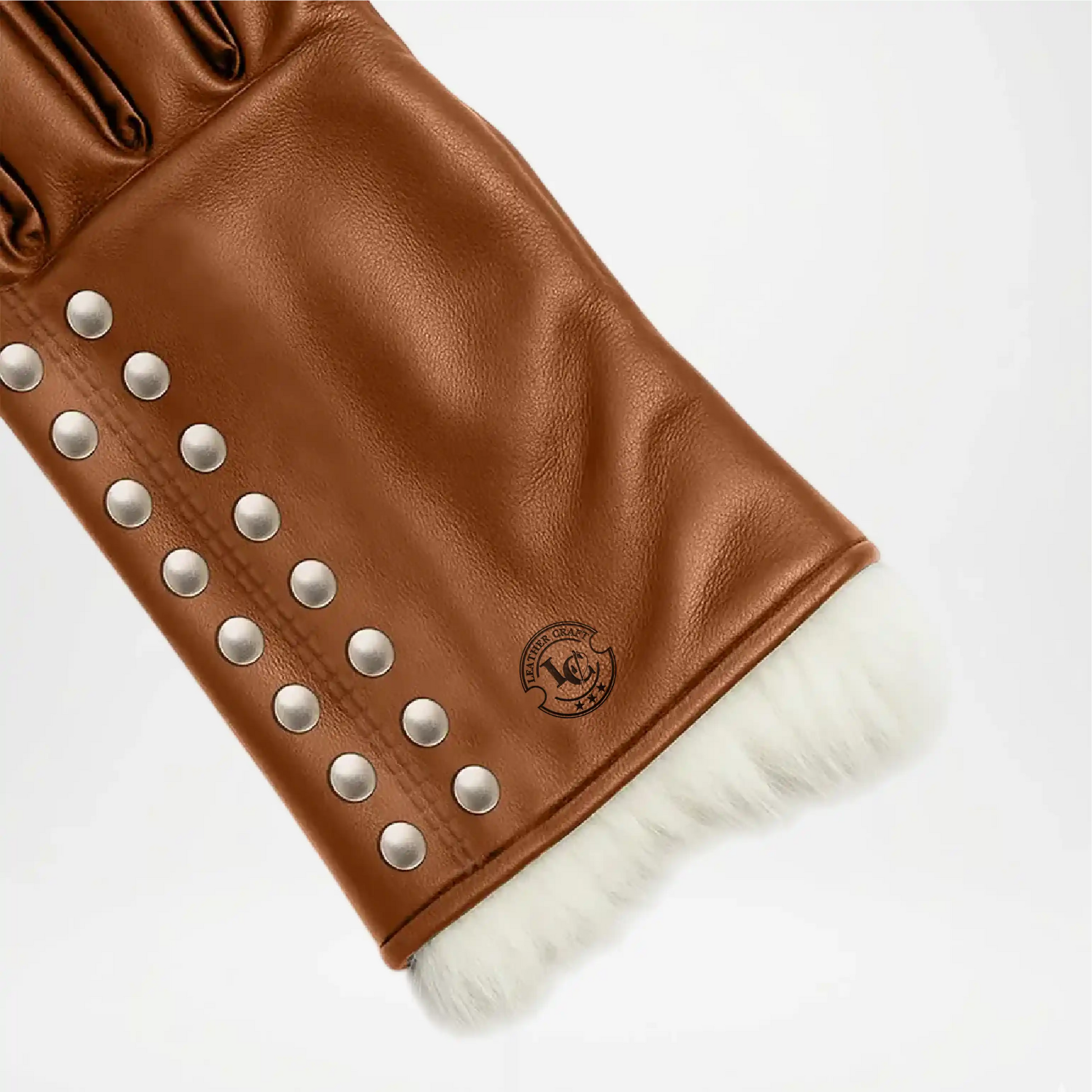 Brown leather glove with studs and white fur lining Close up