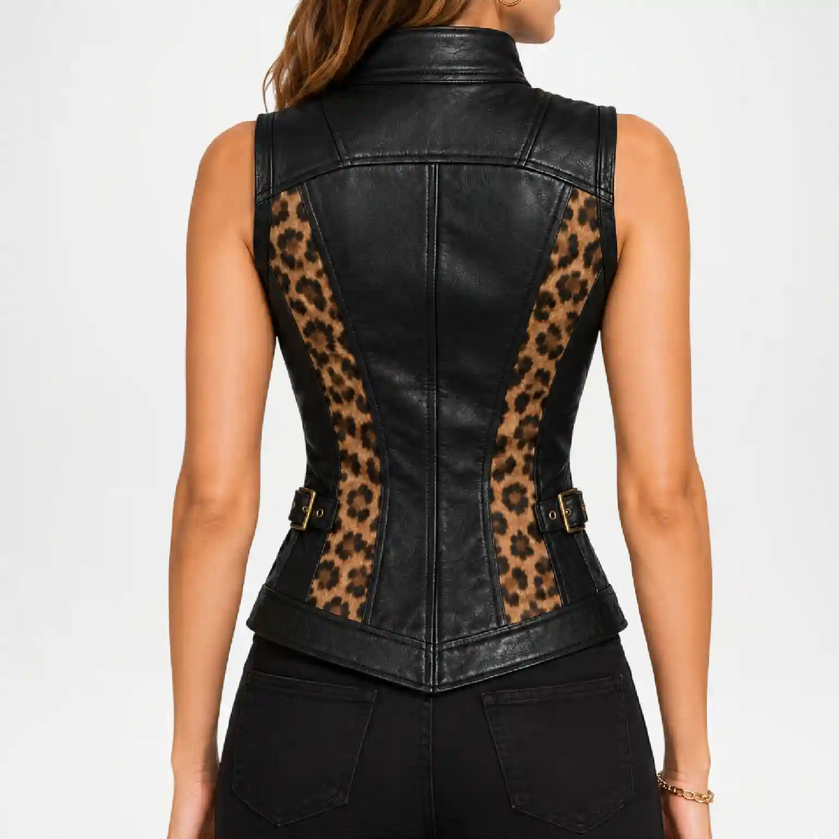 Rear view of a sleeveless black faux-leather vest with leopard-print side panels and gold-tone buckle details, worn by a model against a light gray studio background.