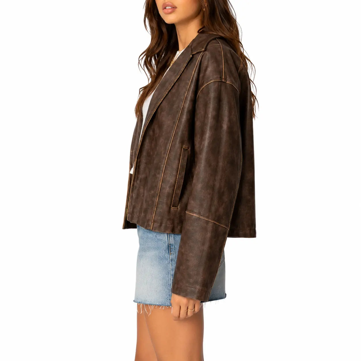 Women's distressed brown oversized leather jacket side view on white background