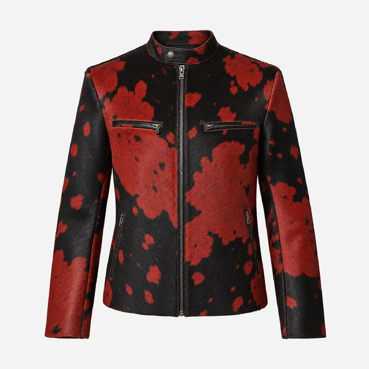 A women's faux-leather jacket featuring a bold red and black cow-print pattern, a mock neck, and a front zipper closure, shown against a plain light gray background.