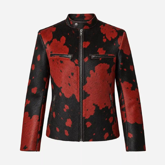 A women's faux-leather jacket featuring a bold red and black cow-print pattern, a mock neck, and a front zipper closure, shown against a plain light gray background.