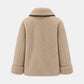 A beige sherpa fleece jacket shown from the back, featuring a high collar with a thin black trim and cuffed sleeves, set against a light gray background.