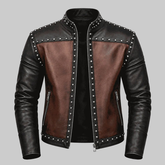 A men's leather jacket with a black and brown color-blocked design, featuring silver-tone metal studs and zippers, shown against a solid gray background.